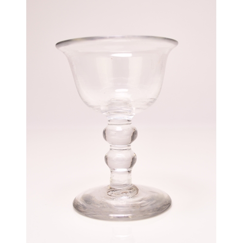 299 - A small English sweetmeat glass, circa 1750, the bell bowl with an averted rim, set above a clear do... 