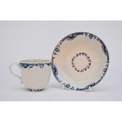 9 - A Worcester coffee cup and saucer, circa 1765-75, moulded with a narrow band of ribbing and painted ... 