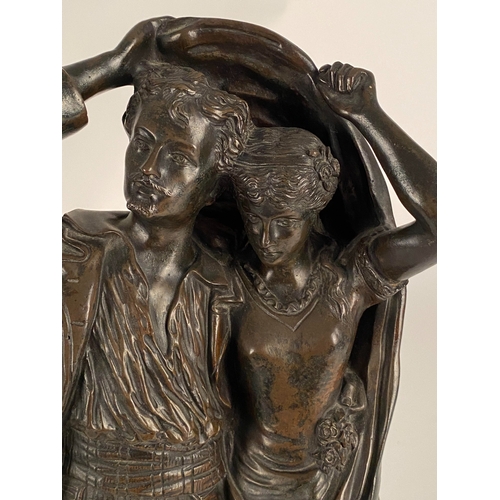 534 - After Fernand Lorrain (19th century), a bronze figure of lovers sheltering from the rain Dark brown ... 