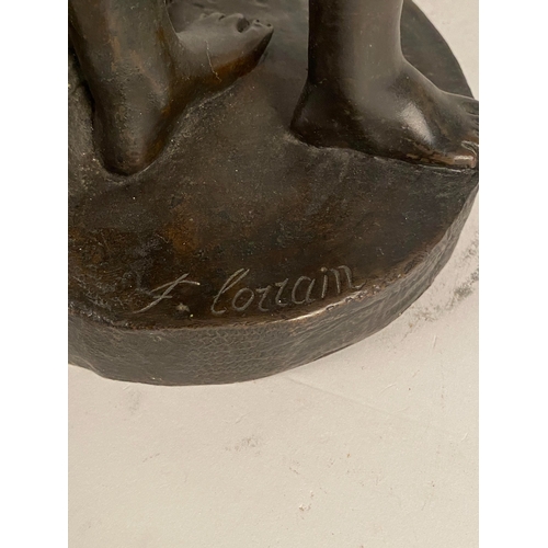 534 - After Fernand Lorrain (19th century), a bronze figure of lovers sheltering from the rain Dark brown ... 