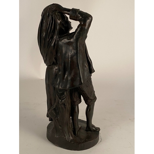 534 - After Fernand Lorrain (19th century), a bronze figure of lovers sheltering from the rain Dark brown ... 