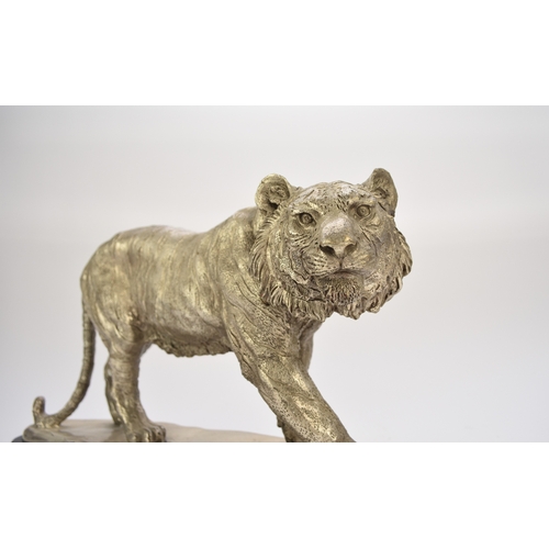 542 - A white metal plated cast resin figure of a tiger Naturalistically modelled standing four square, on... 