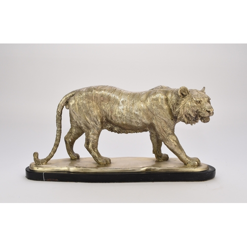 542 - A white metal plated cast resin figure of a tiger Naturalistically modelled standing four square, on... 