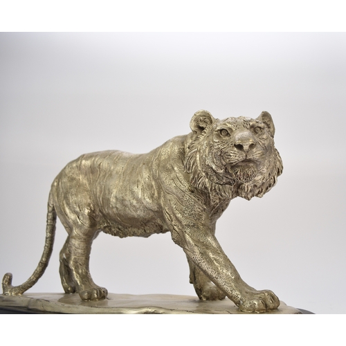 542 - A white metal plated cast resin figure of a tiger Naturalistically modelled standing four square, on... 