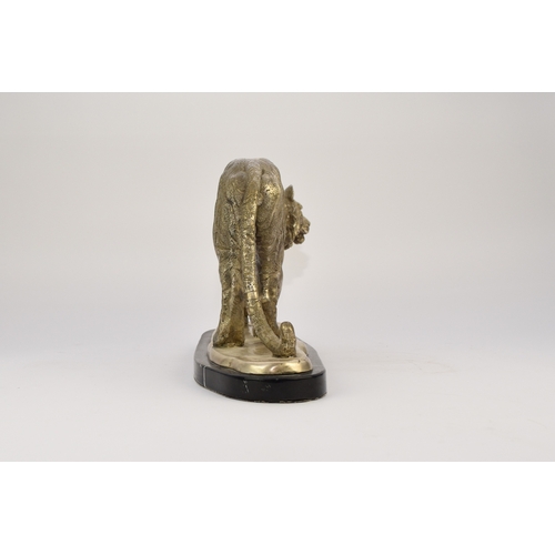 542 - A white metal plated cast resin figure of a tiger Naturalistically modelled standing four square, on... 