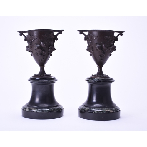 550 - A pair of French bronze and marble vases Circa 1900, the vases of amphora shape with twin handles, c... 