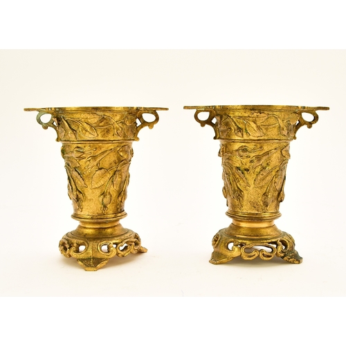 551 - A pair of French ormolu vases, circa 1900 Of tapering form with twin scroll handles and set on tri-l... 