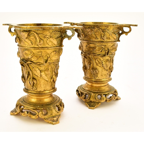 551 - A pair of French ormolu vases, circa 1900 Of tapering form with twin scroll handles and set on tri-l... 