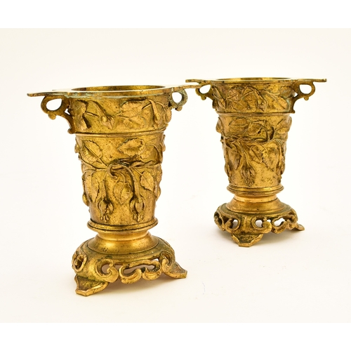 551 - A pair of French ormolu vases, circa 1900 Of tapering form with twin scroll handles and set on tri-l... 