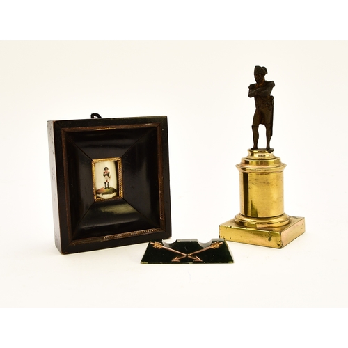 554 - An assembled group of Napoleonic interest, 19th century Including: A small bronze figure of a standi... 