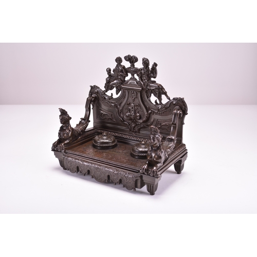 556 - A late 19th century bronze desk standish Of architectural form and cast in relief throughout, the ba... 