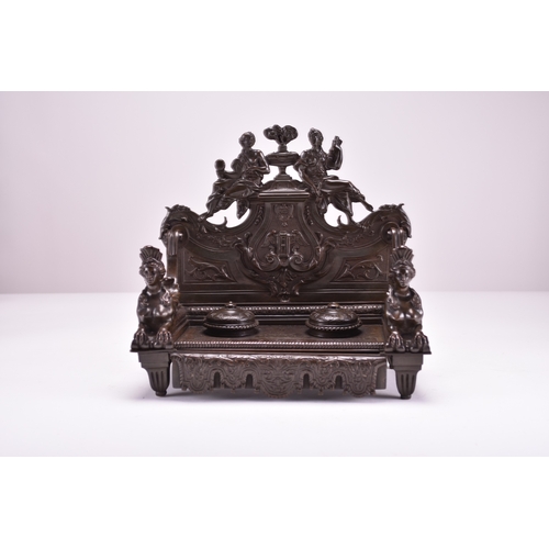 556 - A late 19th century bronze desk standish Of architectural form and cast in relief throughout, the ba... 