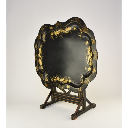 560 - A Victorian papier mâché tray on later stand Of serpentine outline, the cavetto finely gilt with bir... 