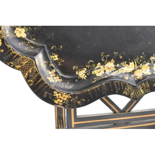 560 - A Victorian papier mâché tray on later stand Of serpentine outline, the cavetto finely gilt with bir... 