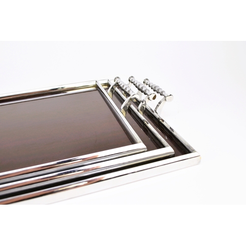 563 - A graduated set of three art deco style service trays Of rectangular outline, the chromium-plated fr... 