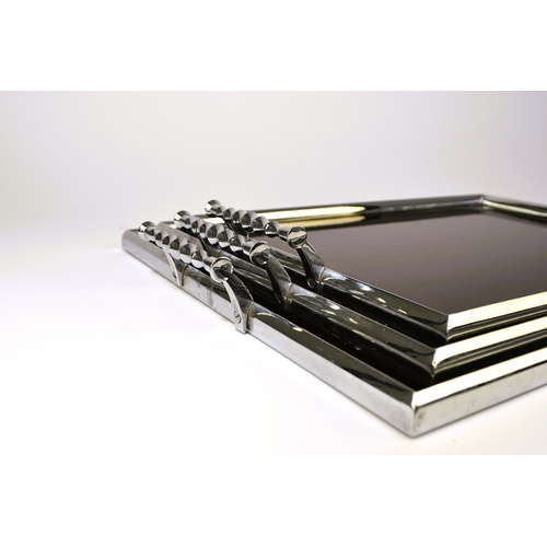 563 - A graduated set of three art deco style service trays Of rectangular outline, the chromium-plated fr... 