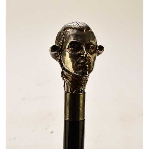 569 - A white metal figural cane, probably German The top modelled as a portrait of Mozart, stamped 925, o... 