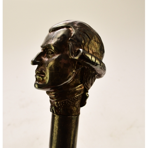 569 - A white metal figural cane, probably German The top modelled as a portrait of Mozart, stamped 925, o... 