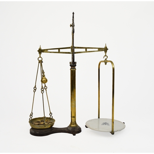 576 - A set of late Victorian cast iron and brass counter top scales By Avery, of balance beam type with c... 