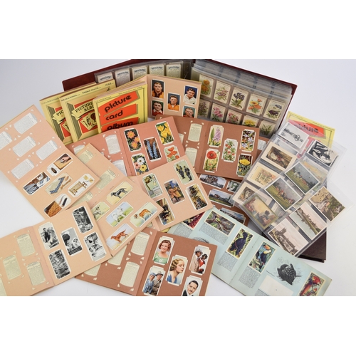 584 - A collection of cigarette cards including Wills and Players sets in album 