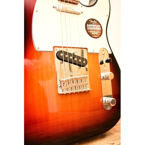 591 - An American Fender Telecaster electric guitar, 2014 In tobacco sunburst with white pick guard, seria... 