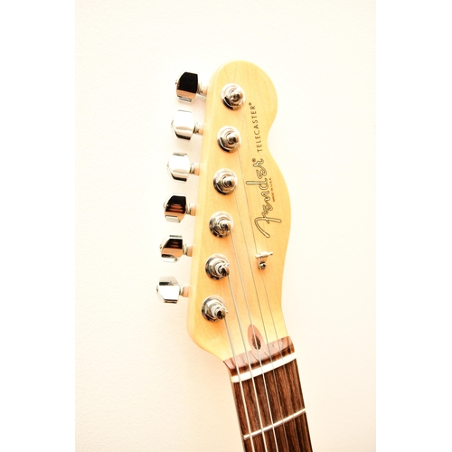 591 - An American Fender Telecaster electric guitar, 2014 In tobacco sunburst with white pick guard, seria... 