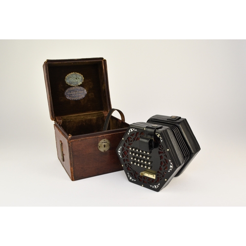 592 - An early 20th century squeeze box concertina Ebonised rosewood inlaid with mother-of-pearl, five fol... 