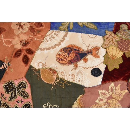 596 - A Victorian embroidered patchwork wall hanging, dated 1892 Worked in asymmetrical coloured fabrics, ... 