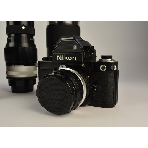 602 - A collection of roll film cameras and lenses To include: Two Nikon F2 35mm SLR camera bodies, circa ... 