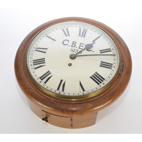 607 - An oak cased industrial fusee wall clock, dated 1938 With plain circular oak case, the 12 inch white... 