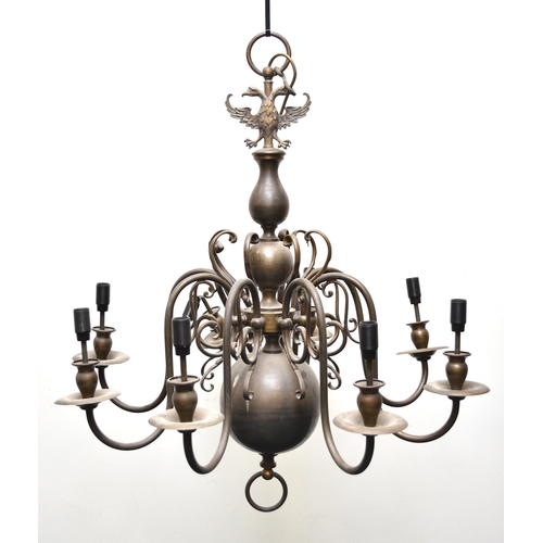 653 - Two Dutch style brass chandeliers Both fitted for electricity, both with baluster stems, the first i... 