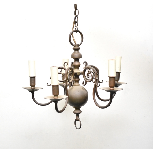 653 - Two Dutch style brass chandeliers Both fitted for electricity, both with baluster stems, the first i... 