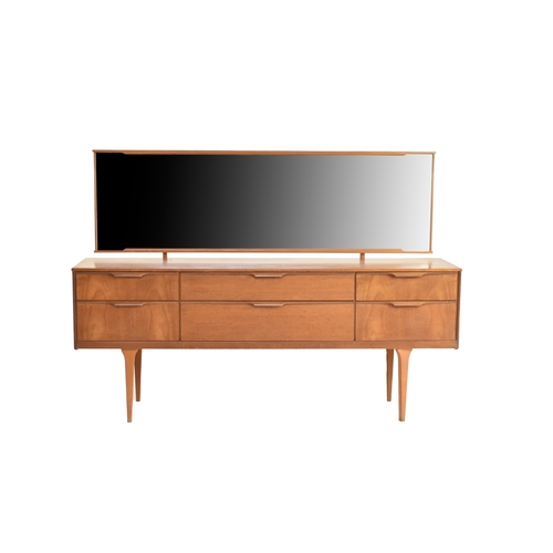 661 - An Austinsuite mid-20th century teak mirror-backed bedroom unit, with six drawers, raised on taperin... 