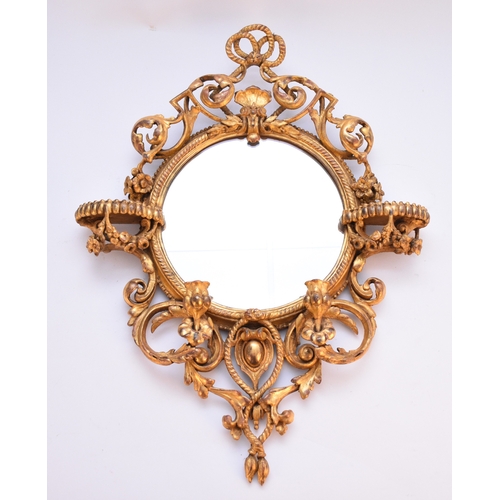 663 - A rococo revival giltwood girandole wall mirror The circular plate within a rope-twist frame applied... 