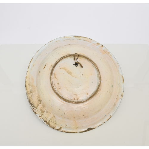 149 - An English delftware charger, 18th century, painted in polychrome with a building to the centre and ... 