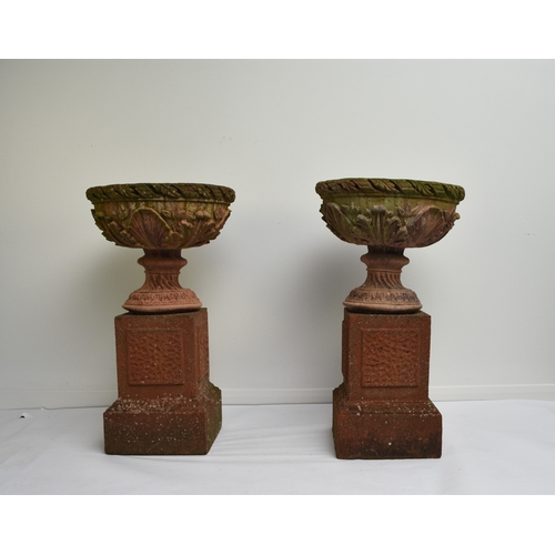 220 - A pair of buff terracotta garden urns First half 20th century, the rims moulded with acanthus leaves... 