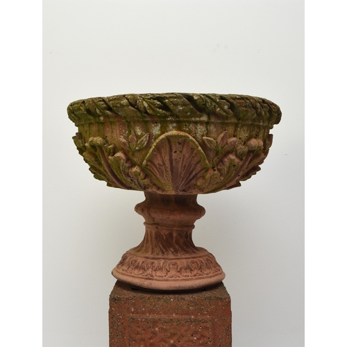 220 - A pair of buff terracotta garden urns First half 20th century, the rims moulded with acanthus leaves... 