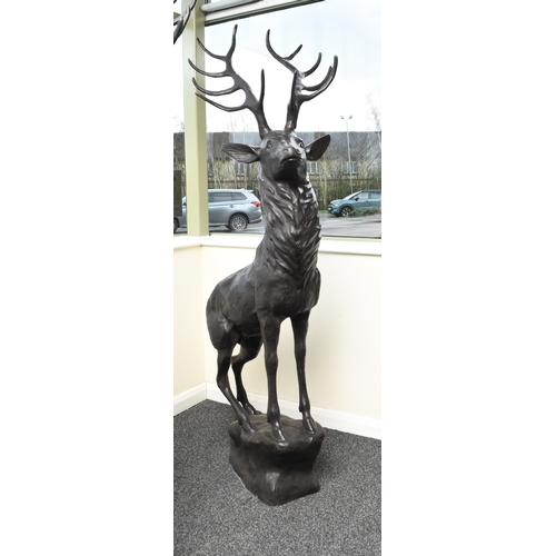 221 - A bronze garden statue of a stag Modern, modelled standing four square on a rocky outcrop. 200cm hig... 