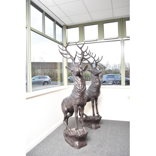 221 - A bronze garden statue of a stag Modern, modelled standing four square on a rocky outcrop. 200cm hig... 