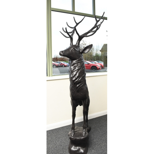 222 - A bronze garden statue of a stag Modern, modelled standing four square on a rocky outcrop. 204cm hig... 