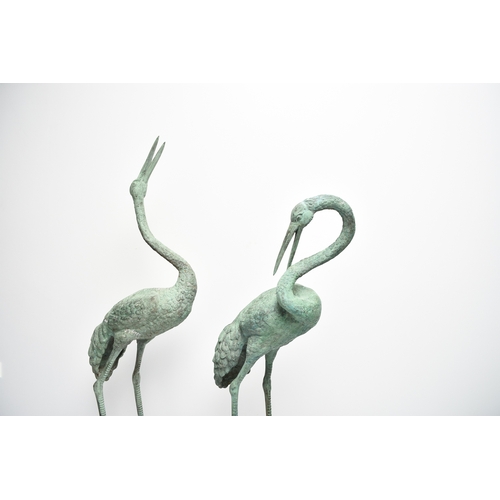 223 - A pair of bronze garden statues of crane birds, 20th century Both modelled standing, one with head r... 