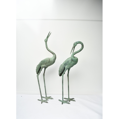223 - A pair of bronze garden statues of crane birds, 20th century Both modelled standing, one with head r... 