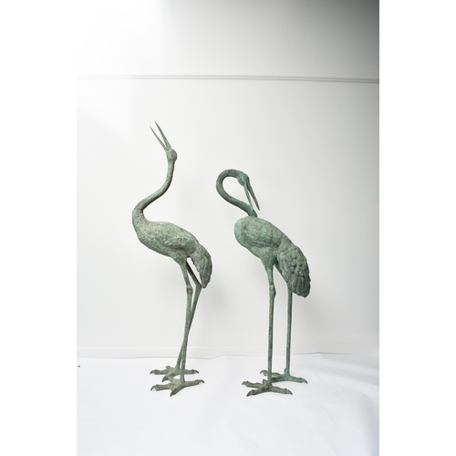 223 - A pair of bronze garden statues of crane birds, 20th century Both modelled standing, one with head r... 