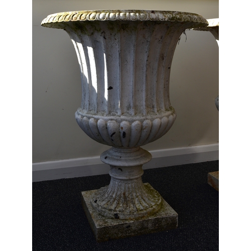 219 - A pair of cast iron garden urns, late Victorian Of campana form, painted white. 76cm high (2) Condit... 