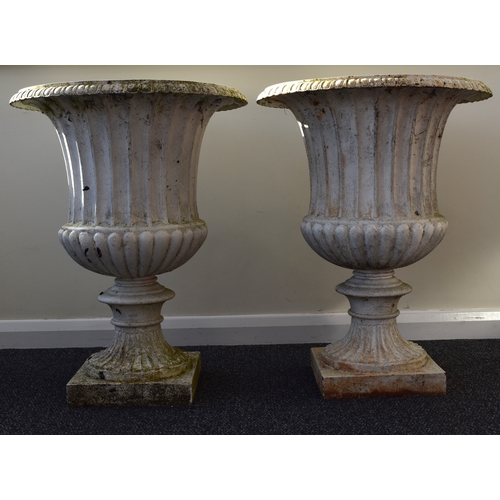 219 - A pair of cast iron garden urns, late Victorian Of campana form, painted white. 76cm high (2) Condit... 