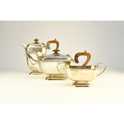 12 - A three piece silver tea service, Harrison Fisher & Co, Sheffield 1963, each piece of canted rectang... 