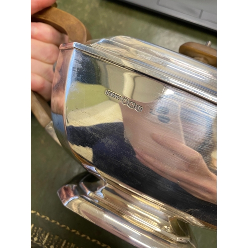 12 - A three piece silver tea service, Harrison Fisher & Co, Sheffield 1963, each piece of canted rectang... 