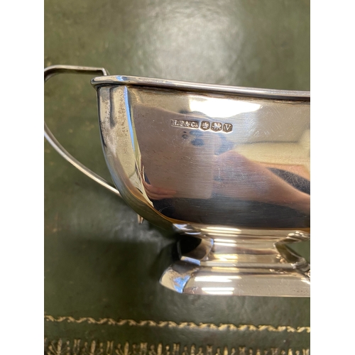 12 - A three piece silver tea service, Harrison Fisher & Co, Sheffield 1963, each piece of canted rectang... 