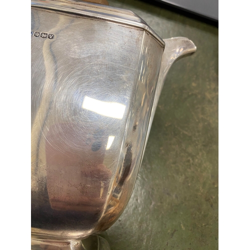 12 - A three piece silver tea service, Harrison Fisher & Co, Sheffield 1963, each piece of canted rectang... 