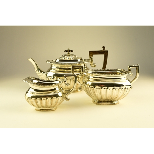 16 - An Edwardian three piece silver tea service, William Aitken, Birmingham 1907, each of rounded rectan... 